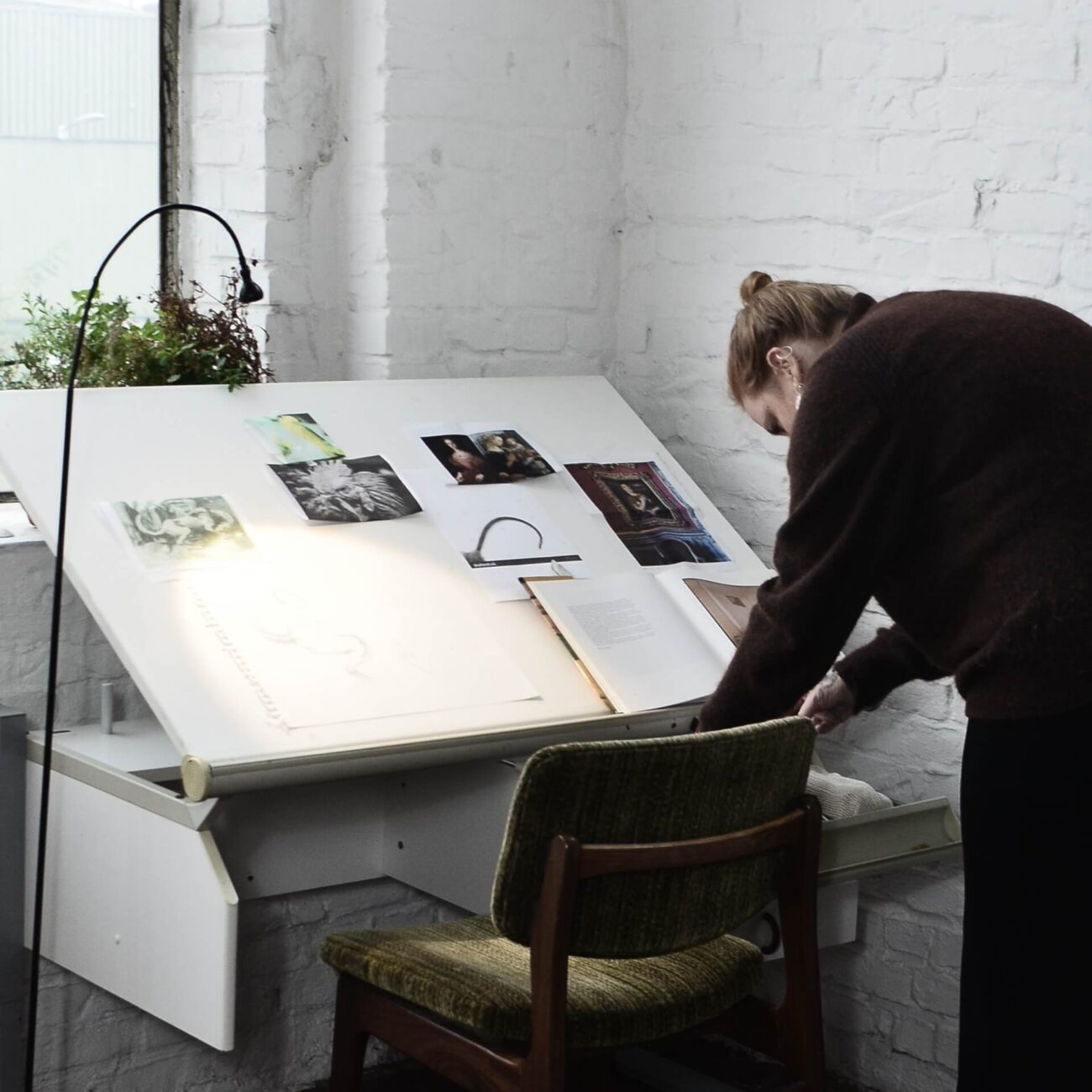 A designer formulating research for a bullion design.