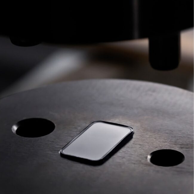 A blank silver bar ready to be stamped with a design.